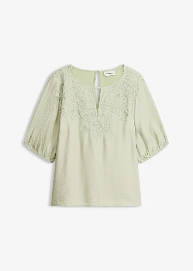 Blusa tipo túnica con bordado y tejido ligeramente transparente